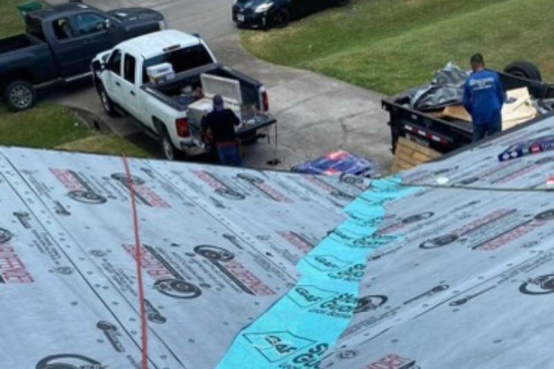 Industrial roofing repair team at a Houston home doing shingles replacement