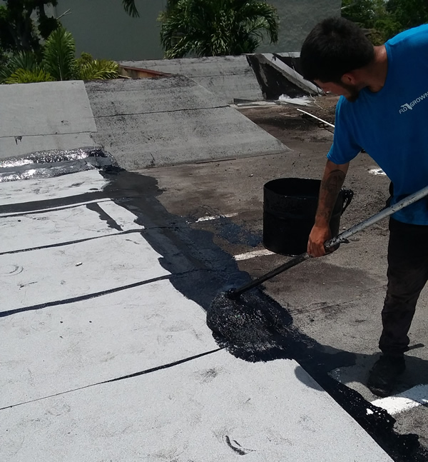 Industrial Roofing Repair crew performing patch repair on a Houston roof